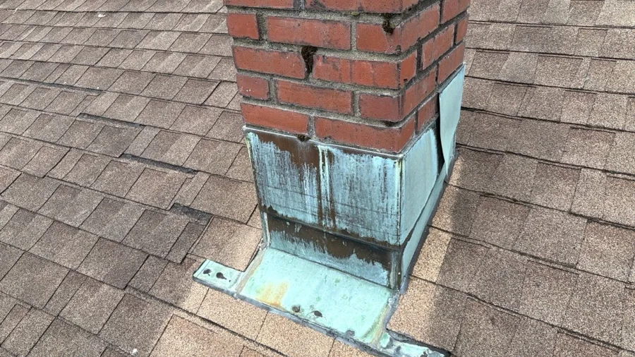 Chimney flashing on an asphalt shingle roof, one of the points checked during an inspection